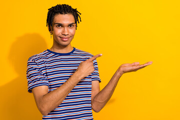Photo of positive man wear trendy outfit arm presenting empty space total sale isolated on yellow...