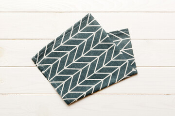 top view with blue kitchen napkin isolated on table background. Folded cloth for mockup with copy space, Flat lay. Minimal style