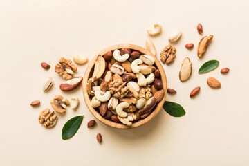 mixed nuts in bowl. Mix of various nuts on colored background. pistachios, cashews, walnuts, hazelnuts, peanuts and brazil nuts - Powered by Adobe