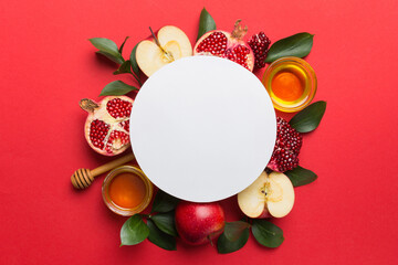 Flat lay composition with Blank flyer poster and symbols jewish Rosh Hashanah holiday attributes on colored background, New Year holiday Traditional. Top view with copy space mock up