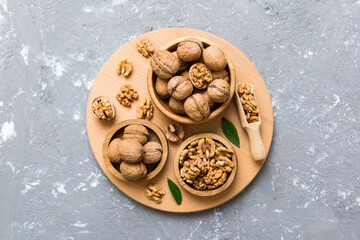 Walnut kernel halves, in a wooden bowl. Close-up, from above on colored background. Healthy eating Walnut concept. Super foods with copy space