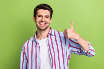 Portrait of pleasant optimistic man with brunet hair wear stylish clothes showing thumb up good job...