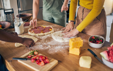 Pizza, dough and hands on wooden table, people cooking with flour and cheese, fruit and food while at home. Nutrition, Italian meal and strawberry in kitchen, baking process with ingredients and chef