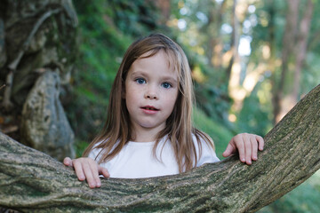 Portrait of joyful child walking in summer park. Small girl 6 years old