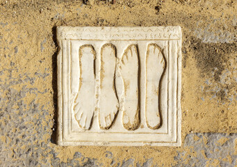 Votive plaques on the floor of the Porta Triumphalis, one of the access gates to the Italica Amphitheater. Roman city of Italica, located in Santiponce, Seville, Andalusia, Spain.