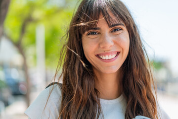Young woman at outdoors with happy expression