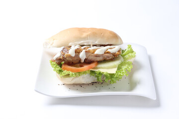 speciality grilled bbq chicken chop burger bun with cheese, vegetables and salad sauce breakfast in plate on white background western chef appetiser halal bakery food restaurant pastry menu for cafe