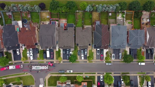 aerial pov of a neighborhood road filled with fire department emergency vehicles 