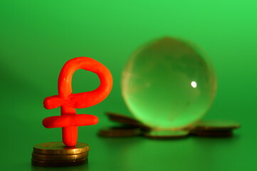 A figure of a ruble with coins on a green background. Financial symbol.