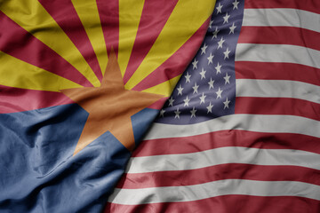 big waving colorful national flag of united states of america and flag of arizona state .