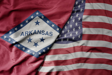 Fototapeta na wymiar big waving colorful national flag of united states of america and flag of arkansas state .