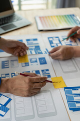 The web ux ui design team is writing code and layers to customize the smartphone front ux ui...