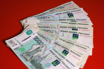 Russian rubles on a red background. Finance and economics.