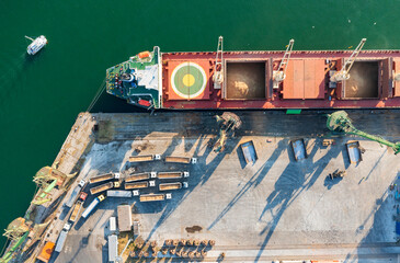 Top view from a drone of a large ship loading grain for export. Water transport