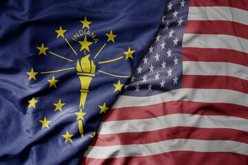 big waving colorful national flag of united states of america and flag of indiana state .