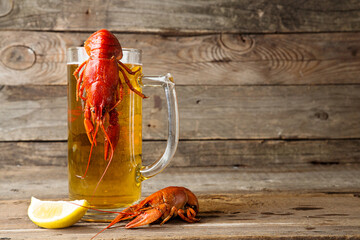 Beer party. Still life with glass of beer, crayfish crawfish against old wooden rustic background.