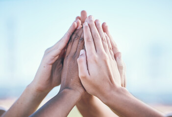 Teamwork, hands and high five by people for sports, support and training goals outdoor. Fitness,...