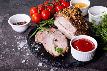 Oven baked pork meat in mustard grains with tomato souce