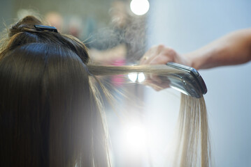 Hair straightening with keratin and a hair iron