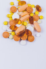 Tablets and pills on white background. Various treatments mixed. Variety of pills and medication. Close up. Macro. Medical concept. Top view.