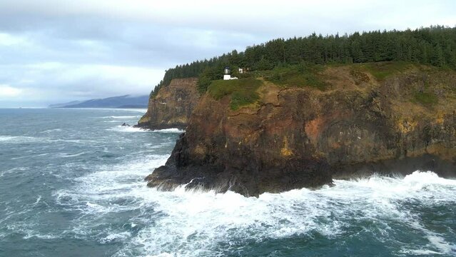 Ocean waves crashing into cliffs at the Oregon coast Aerial view over Cape Meares lighthouse