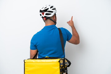 Young caucasian man with thermal backpack isolated on white background pointing back with the index finger