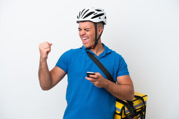 Young caucasian man with thermal backpack isolated on white background with phone in victory position
