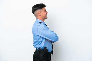 Young police caucasian man isolated on white background in lateral position