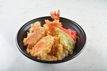 japanese deep fried crispy tempura prawn and vegetables rice in black bowl on wood tray white marble table background chef cook healthy poke bowl halal vegan food menu for cafe
