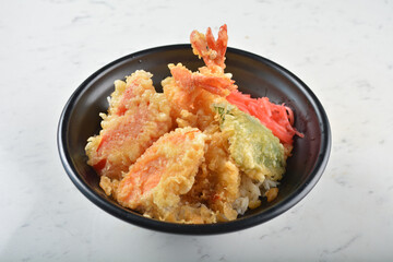 japanese deep fried crispy tempura prawn and vegetables rice in black bowl on wood tray white marble table background chef cook healthy poke bowl halal vegan food menu for cafe