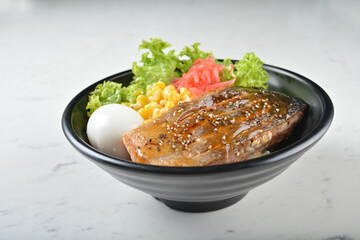 japanese bbq grill teriyaki salmon seafood with boiled onsen egg, corn, red ginger and rice in black bowl on wood tray white marble table background chef cook healthy poke bowl halal food menu