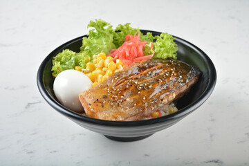 japanese bbq grill teriyaki salmon seafood with boiled onsen egg, corn, red ginger and rice in black bowl on wood tray white marble table background chef cook healthy poke bowl halal food menu