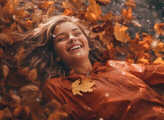 Young lady lies laying in a pile of autumn leaves