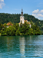 Fototapeta na wymiar Idyllic landscape of Lake Bled with the Pilgrimage church of the Assumption in a small island. Bled, Slovenia, Europe
