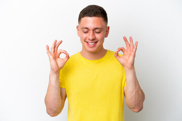 Young brazilian man isolated on white background in zen pose