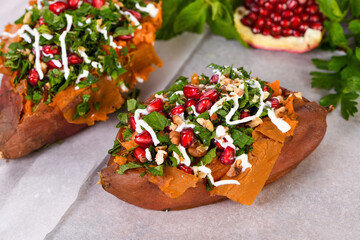 Baked stuffed sweet potatoes filled with walnuts, fresh herbs, mint and pomegranate seeds. The...
