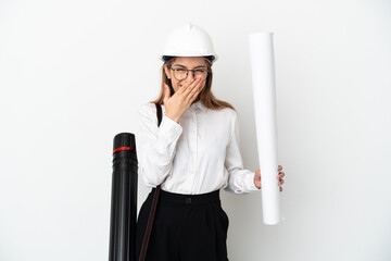 Young architect woman with helmet and holding blueprints isolated on white background happy and smiling covering mouth with hand