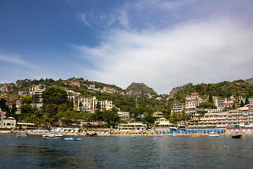 Fototapeta na wymiar A view of Taormina from the bay with beach scenery