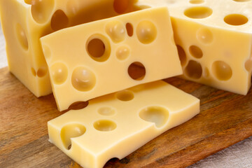 Cheese collection, french hard cheese with holes emmentaler close up