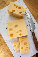 Cheese collection, french hard cheese with holes emmentaler close up