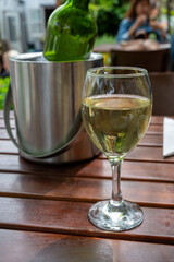 Drinking cold white wine on outdoor terrace, summer vacation, close up