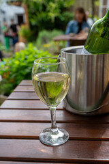Drinking cold white wine on outdoor terrace, summer vacation, close up