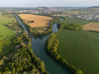 Panoramic aerial view on green premier cru champagne vineyards and fields near village Hautvillers and  Cumieres and Marne river valley, Champange, France © barmalini