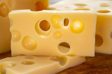 Cheese collection, french hard cheese with holes emmentaler close up
