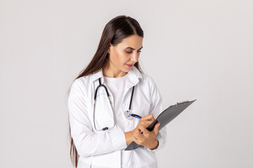 medicine, profession and healthcare concept - happy smiling female doctor in white coat with clipboard and pen on white background