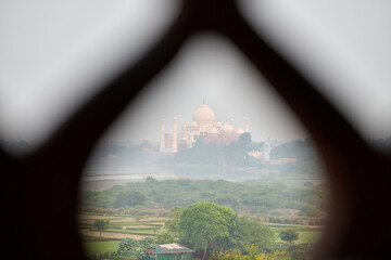 Taj Mahal white marble mausoleum landmark in Agra, India, view through chain link fence to...