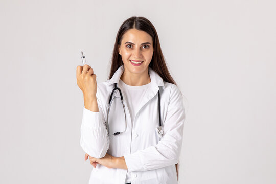 Smiling female doctor with stethoscope holding syringe on white background. Medicine, immunization and health care. vaccination concept. High quality photo