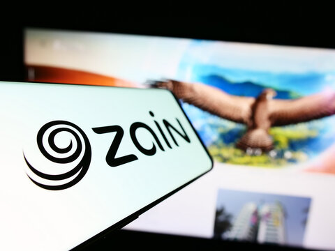 Stuttgart, Germany - 08-05-2023: Smartphone with logo of Mobile Telecommunications Company K.S.C.P. (Zain) on screen in front of business website. Focus on left of phone display.