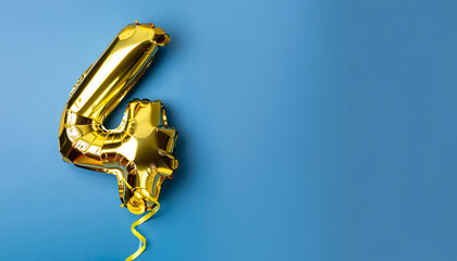 Banner with number 4 golden balloon with copy space. Four years anniversary celebration concept on...