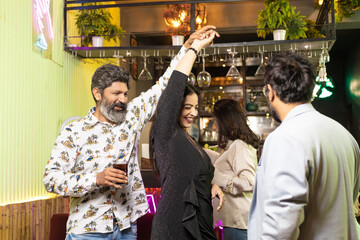 Indian couple dancing at restaurant